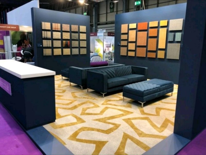 Danfloor stand at the Care Show 2022 featuring the Emerson sofa and ottoman designed by Shackletons