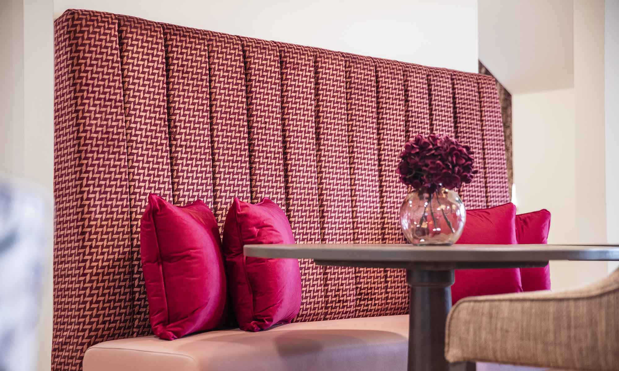 Banquette seating with table with vase on top