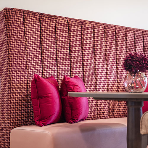 Banquette seating in bright pink
