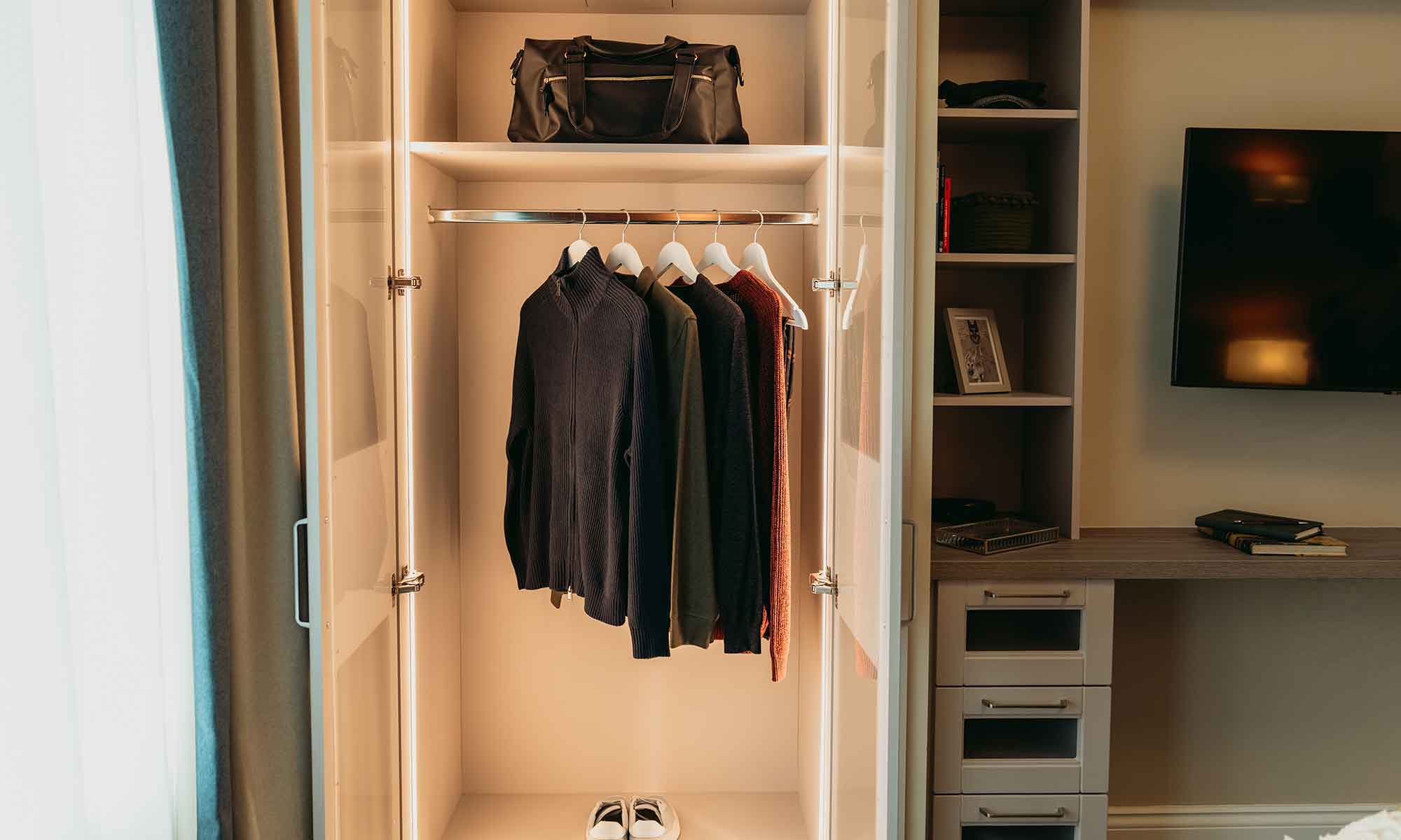 Dementia friendly wardrobe with clothes hanging and drawers