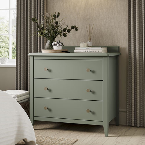 A green chest of drawers in a bedroom