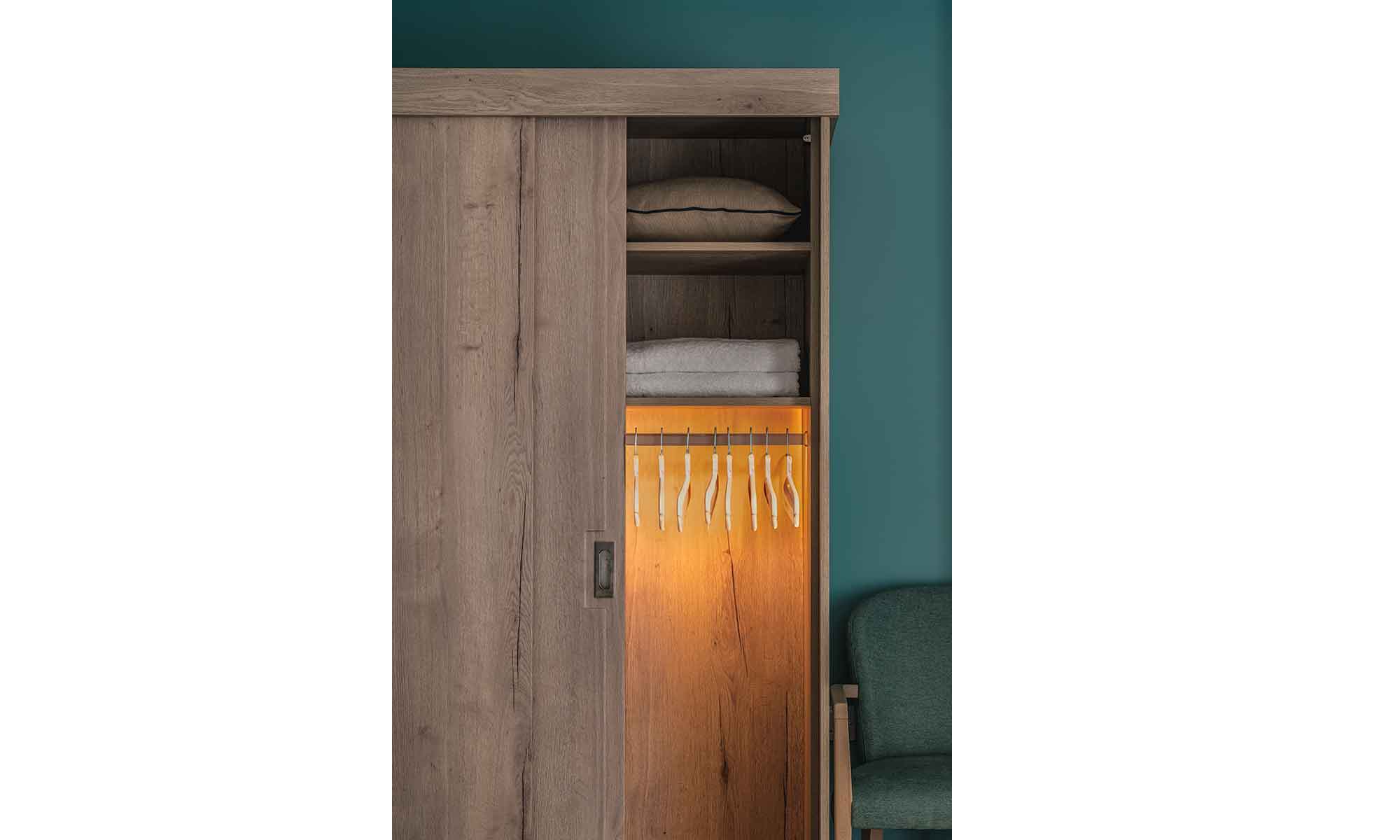 Bespoke sliding wardrobe with sliding door and illuminated hanging