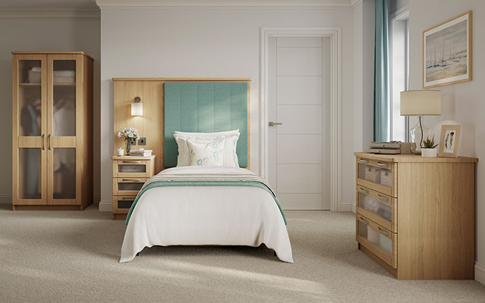 Marlow dementia bedroom collection. Image shows wardrobe, fitted headboard, bedside cabinet and drawers.