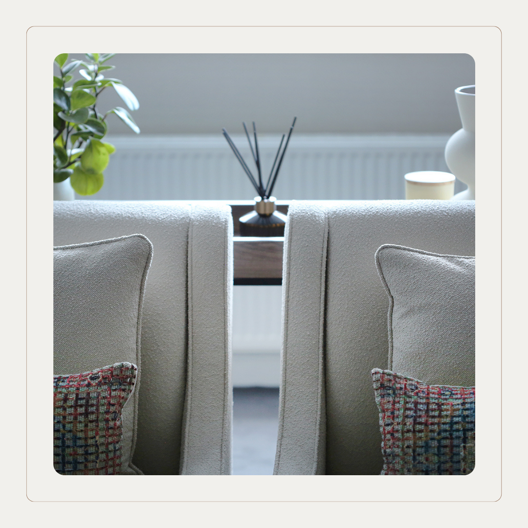 Close-up of care home lounge seating upholstered in soft Cloud Dancer neutral fabric, showcasing texture, stitching detail and calming Pantone Colour of the Year tones.