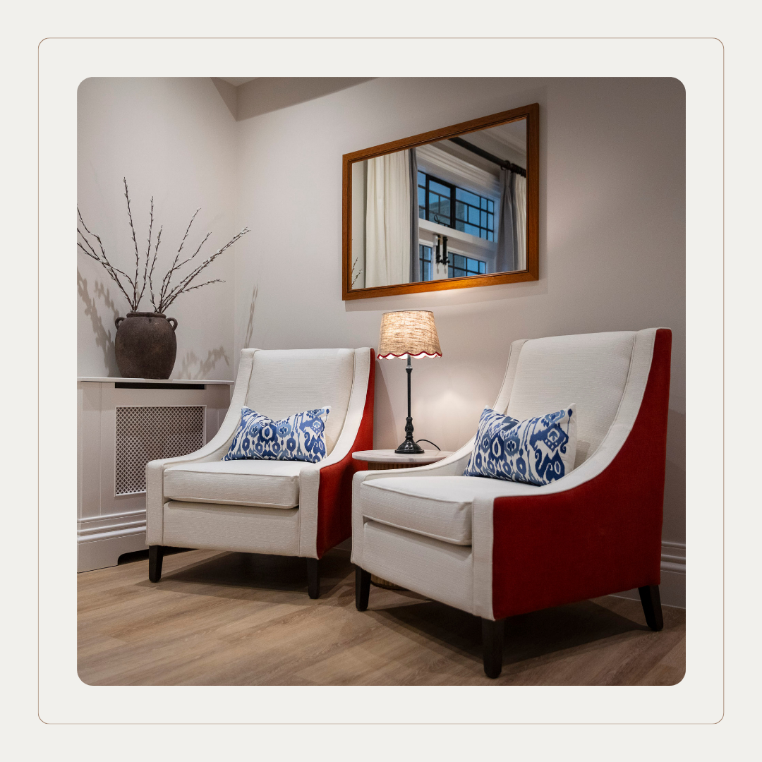 High-back care home armchairs upholstered in Cloud Dancer neutral fabric, demonstrating how Pantone Colour of the Year supports comfort, contrast and elegant senior living design.