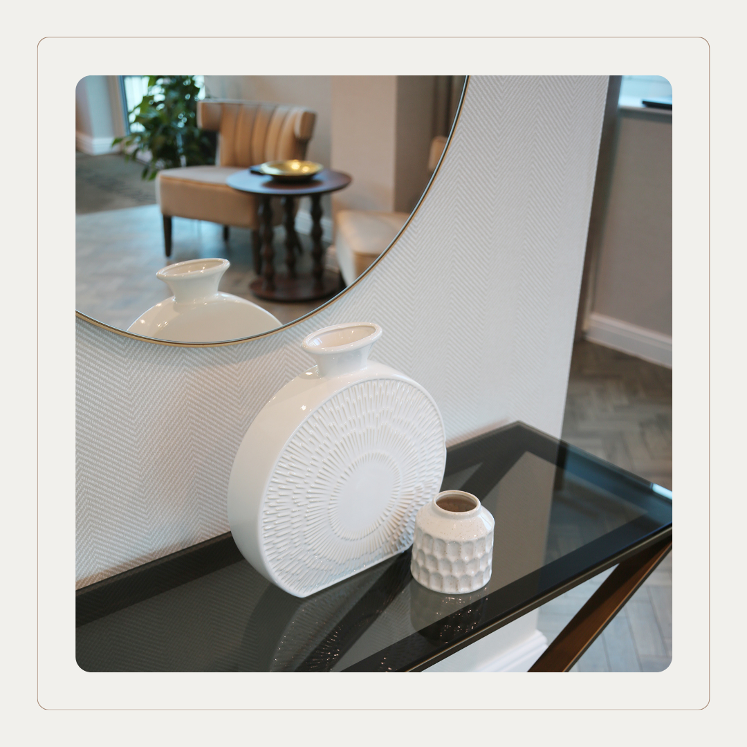 Care home interior styling with console table, mirror and accessories set against Cloud Dancer inspired neutral finishes for a calm, contemporary senior living space.