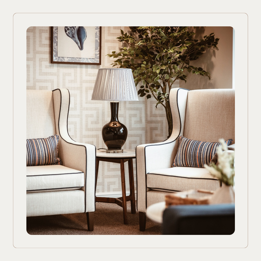 Pair of upholstered lounge chairs in a care home seating area, styled in Cloud Dancer neutral tones from Pantone Colour of the Year to create a warm, welcoming interior.