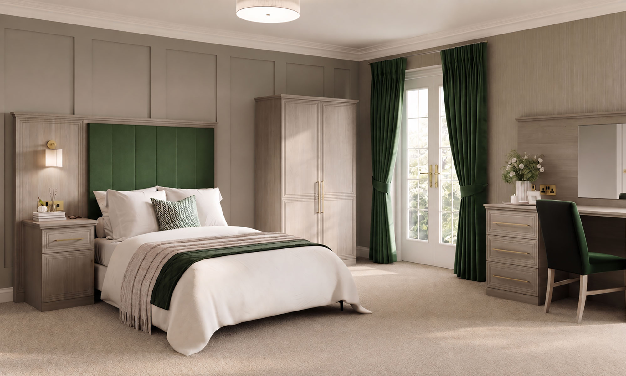 Care home bedroom with a green upholstered headboard, matching curtains, layered bedding and light wood furniture.